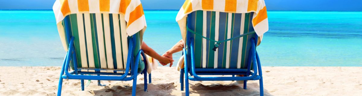 Two beach chairs facing ocean depiction vacation on beach